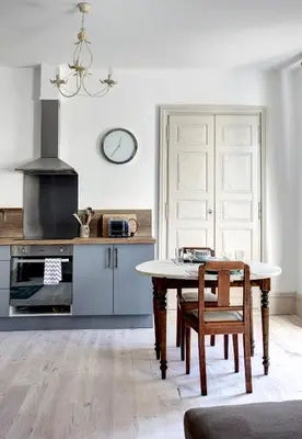 a kitchen with a table and a dining room at Appartements du Vin in Caudiès-de-Fenouillèdes