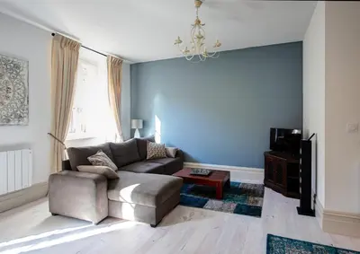 a living room with a couch and a table at Appartements du Vin in Caudiès-de-Fenouillèdes
