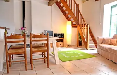 a living room with a table and chairs and a couch at Domaine de la Matte in Conques-sur-Orbiel