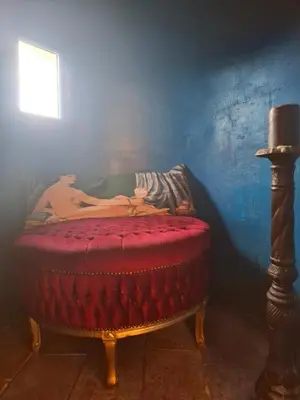 a man laying on a bed in a room at B&B Château de Fajac la Selve in Pech-Luna