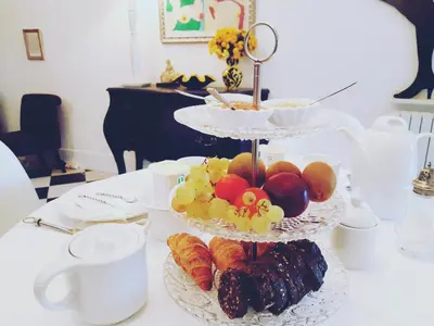 a white table with three tiered plates of food at B&B Château de Fajac la Selve in Pech-Luna