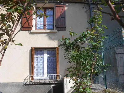 a building with two windows and a balcony at Maison Palmeral in Coustaussa