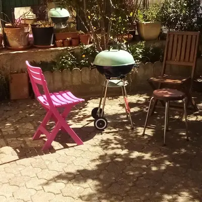 a grill and two chairs and a grill and two chairs at Maison Palmeral in Coustaussa