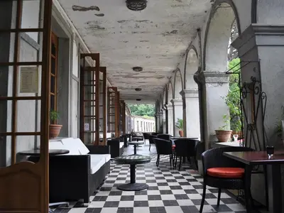 a restaurant with tables and chairs and a checkered floor at APOSTROPHE Chambres d'Hôtes in Montolieu