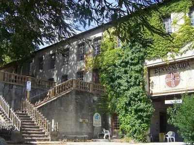 an old building with stairs and ivy on it at APOSTROPHE Chambres d'Hôtes in Montolieu