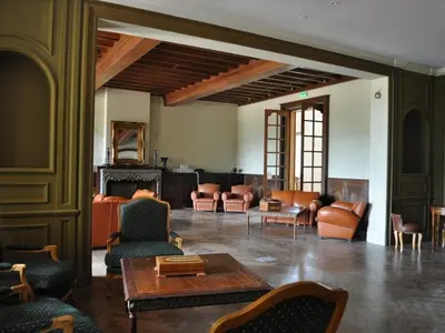 a living room with couches and a table and chairs at APOSTROPHE Chambres d'Hôtes in Montolieu