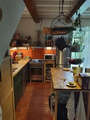 a large kitchen with a counter top and a kitchen island at Stunning view in Cathar country in Cailla