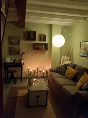 a living room with a couch and a table with candles at Stunning view in Cathar country in Cailla