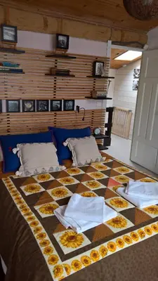a bed with a quilt on top of it at Stunning view in Cathar country in Cailla