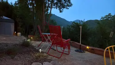 two red chairs and a table on a patio at Stunning view in Cathar country in Cailla
