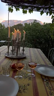 a table with glasses of wine and candles on it at Stunning view in Cathar country in Cailla