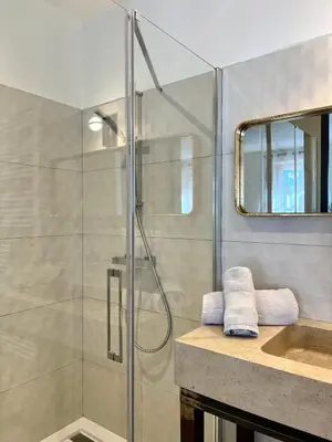 a bathroom with a shower and a sink at LA COUR CARREE - chambres d'hôtes in Carcassonne