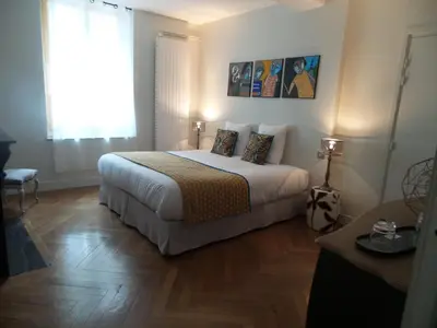 a hotel room with a bed and a window at LA COUR CARREE - chambres d'hôtes in Carcassonne
