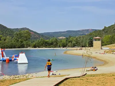 a person running on a beach with a water park at Holiday Home in Quillan near Pyrenees in Quillan