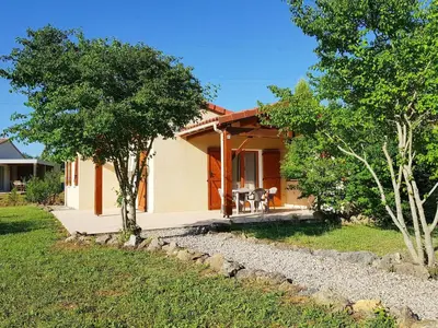a small house with a patio and trees at Holiday Home in Quillan near Pyrenees in Quillan