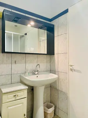 a bathroom with a sink and a mirror at Chambres d'hôtes Le Pessac in Vielmur-sur-Agout