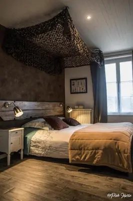 a bedroom with a large bed and a window at Chambres d'hôtes Le Pessac in Vielmur-sur-Agout