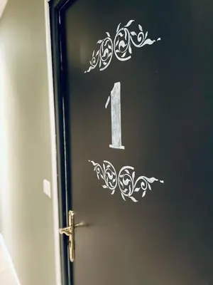 a door with a number one stenciled on it at Chambres d'hôtes Le Pessac in Vielmur-sur-Agout