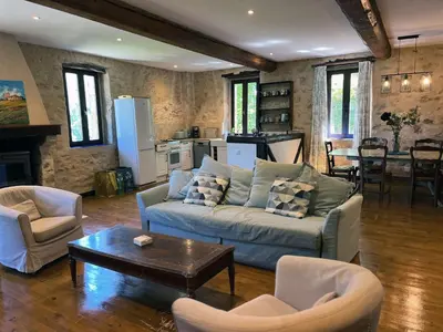 a living room with a couch and chairs and a table at Gites de Montcabirol in Mirepoix