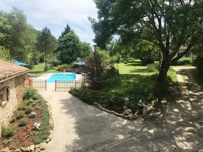 a driveway leading to a yard with a swimming pool at Gites de Montcabirol in Mirepoix