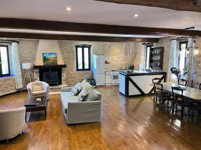 a large living room with a couch and a table at Gites de Montcabirol in Mirepoix