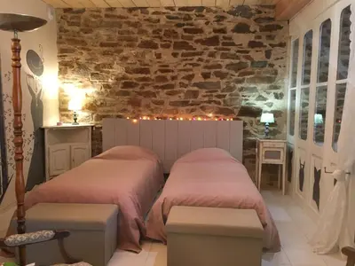 a patio with a table and chairs next to a door at Le roc de l'aigle in Cabrespine