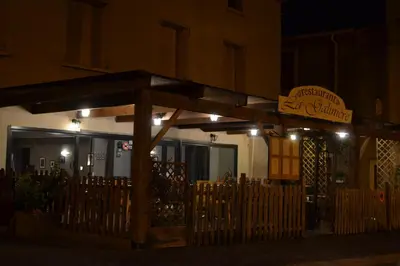 a restaurant with a sign on the side of a building at L'instant Canal in Capestang