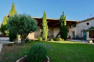 a house with trees and a lawn in front of it at Maison de Margot in Peyriac-Minervois