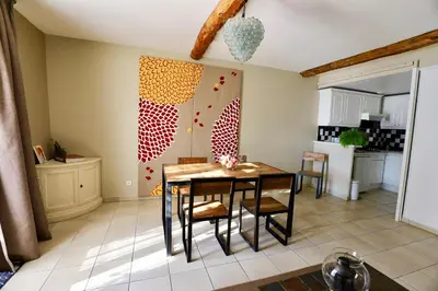 a kitchen with a table and chairs in a room at Maison de Margot in Peyriac-Minervois