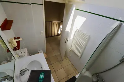 a bathroom with a toilet and a sink and a shower at Maison de Margot in Peyriac-Minervois