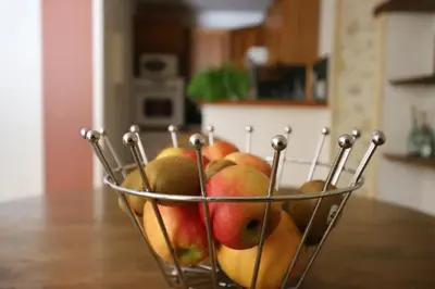 a basket of fruit sitting on top of a table at Maison de Margot in Peyriac-Minervois