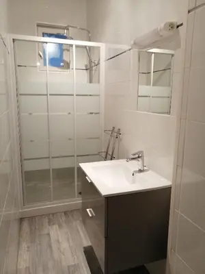 a bathroom with a sink and a shower at La Maison CANTHEZ Wifi in Sigean