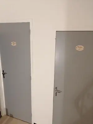 two doors in a room with white walls at La Maison CANTHEZ Wifi in Sigean
