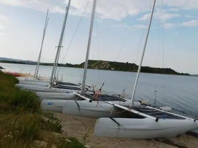 a row of sailboats are lined up on the beach at La Maison CANTHEZ Wifi in Sigean