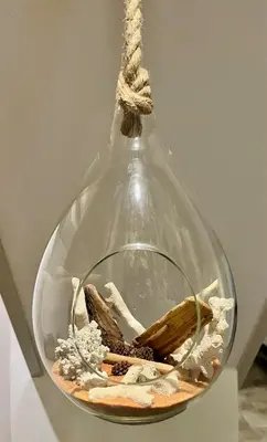a glass vase with some objects in it at La Folie des Remparts in Carcassonne