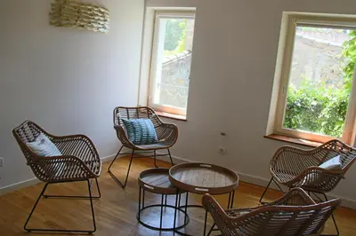 a group of chairs and a table in a room at La Folie des Remparts in Carcassonne