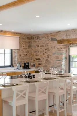 a dining room with a white table and chairs at Domaine de Merlac in Rieussec