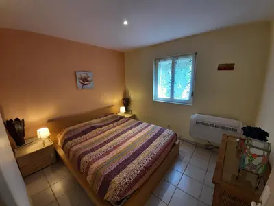 a bedroom with a bed and a window at Lotus in Cébazan