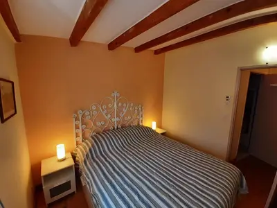 a bedroom with a bed with two lights on it at Lotus in Cébazan