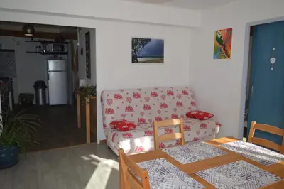 a living room with a couch and a table at El roble in LʼAiguillon
