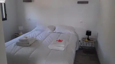 a white bed with towels and a red bow on it at Gites du pech cathare in Leychert