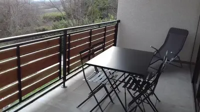 a table and two chairs sitting on a balcony at Gites du pech cathare in Leychert