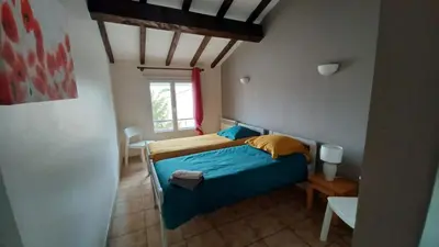 a bedroom with a blue bed and a window at gite echarou agréable maison de famille in Sigean
