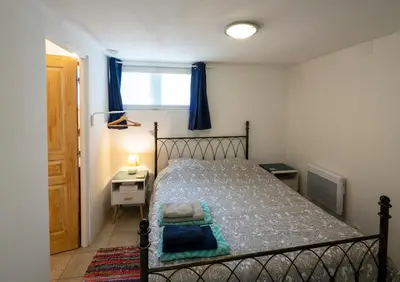 a bedroom with a bed and a window at Horizons Verts Appartement Jasmin in Puivert