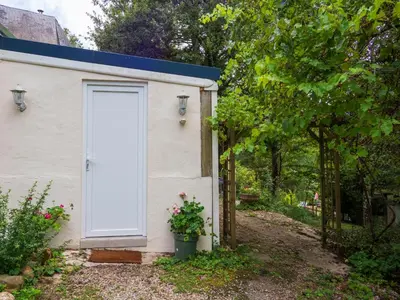a white door on the side of a building at Horizons Verts Appartement Jasmin in Puivert