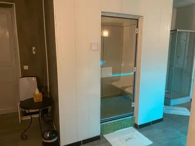 a glass door to a shower in a bathroom at Maison d'hôtes 