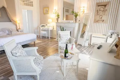 a bedroom with a bed and a table and chairs at Maison d'hôtes 