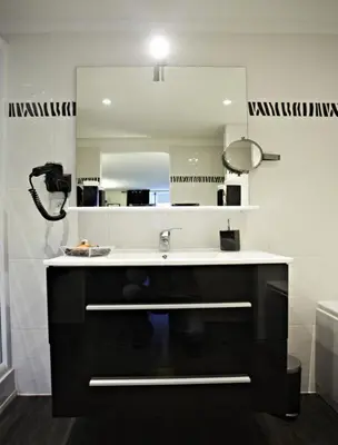 a bathroom with a sink and a mirror at Maison d'hôtes 