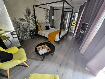 a bedroom with a bed and a table with a mirror at La Pinède D'Estarac in Bages