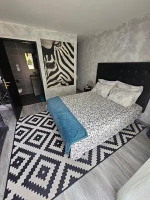 a bedroom with a bed with a blue blanket at La Pinède D'Estarac in Bages